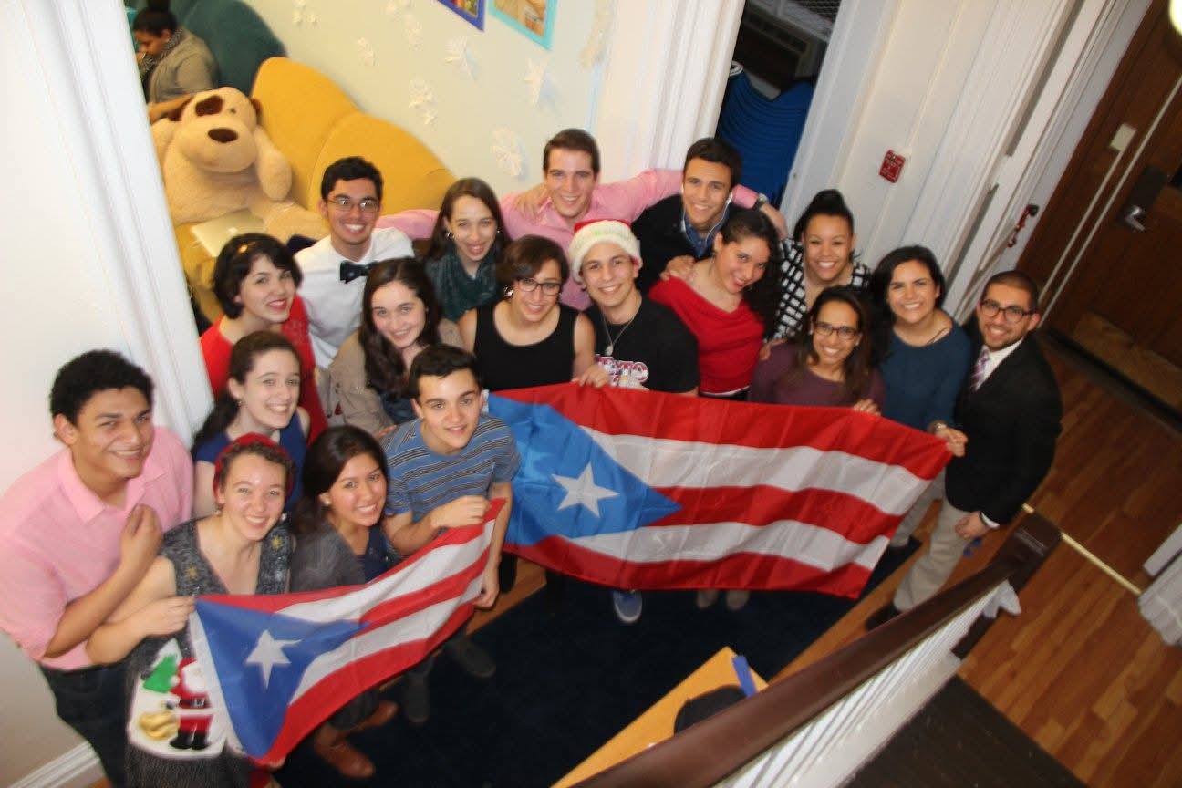 Students holding a Puerto Rican flag inside La Casa